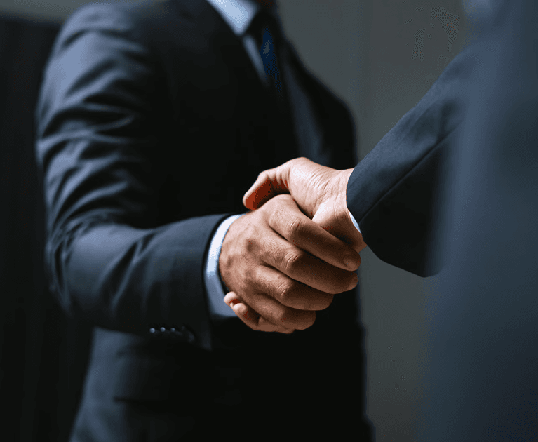 Two business leaders shaking hands